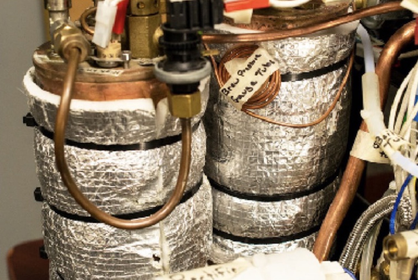 Espresso machine boilers wrapped in fibreglass and aluminium foil insulation