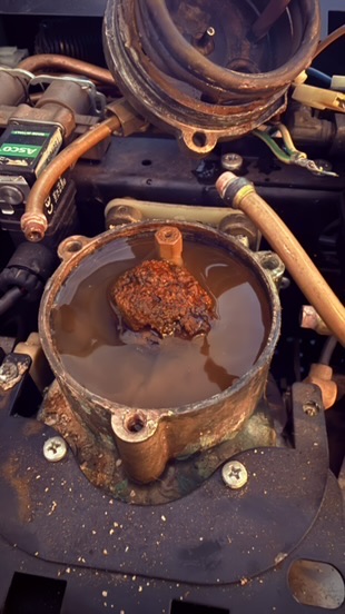 Rusted, scaled group head from a machine run on untreated water